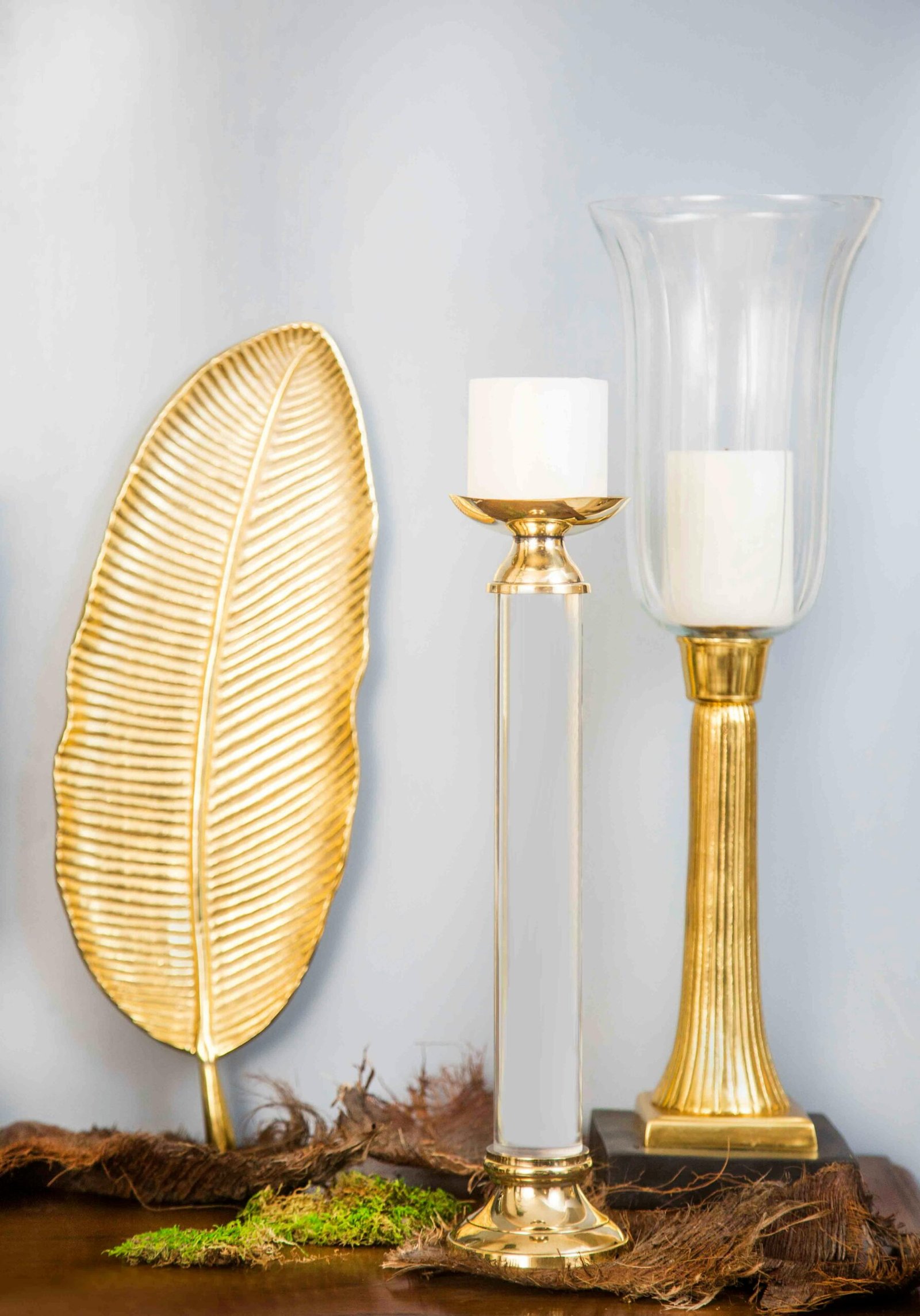 Stylish gold and glass decorations with candle holders for luxurious interior decor.
