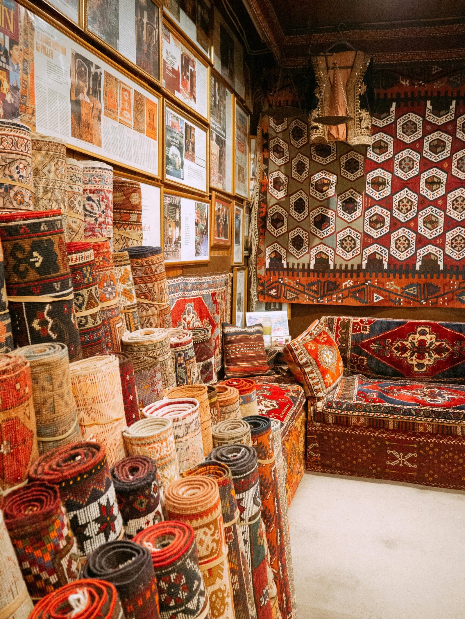Vibrant display of rolled Turkish carpets in an Istanbul bazaar, showcasing intricate patterns and rich colors.